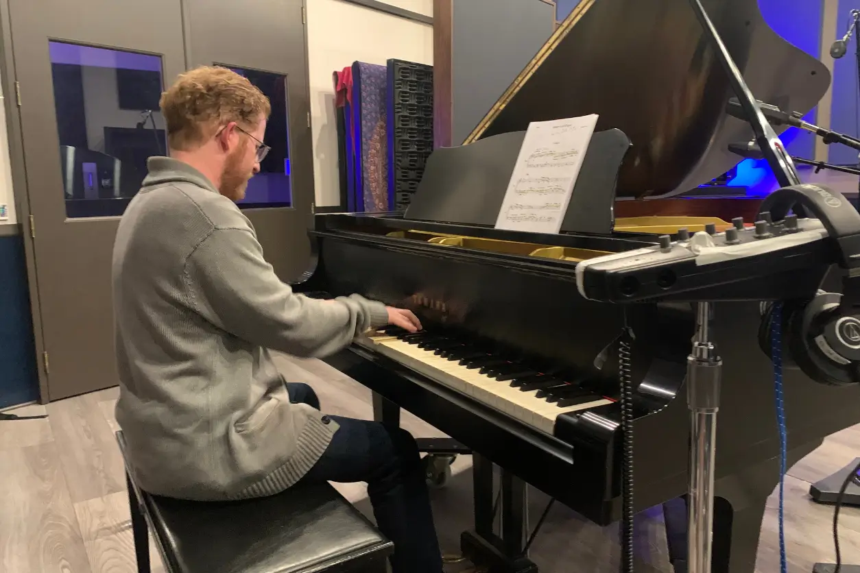 A man sitting at the piano playing music.